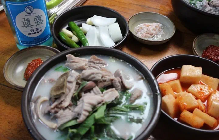 충남식당 국밥과 소주 한 병, 깍두기와 양파 반찬을 함께 차린 상